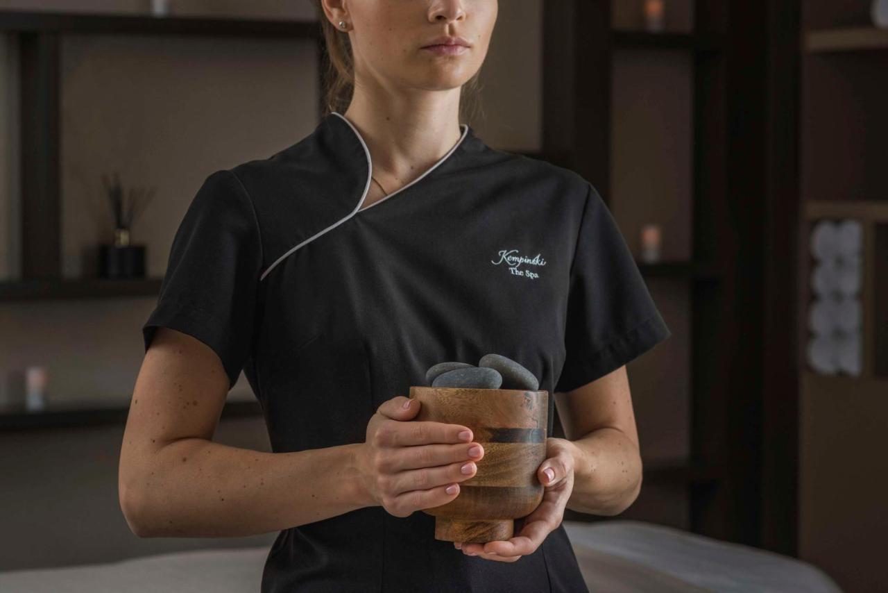 Grand Hotel Kempinski Riga Exterior photo A spa employee holding a glass of tea